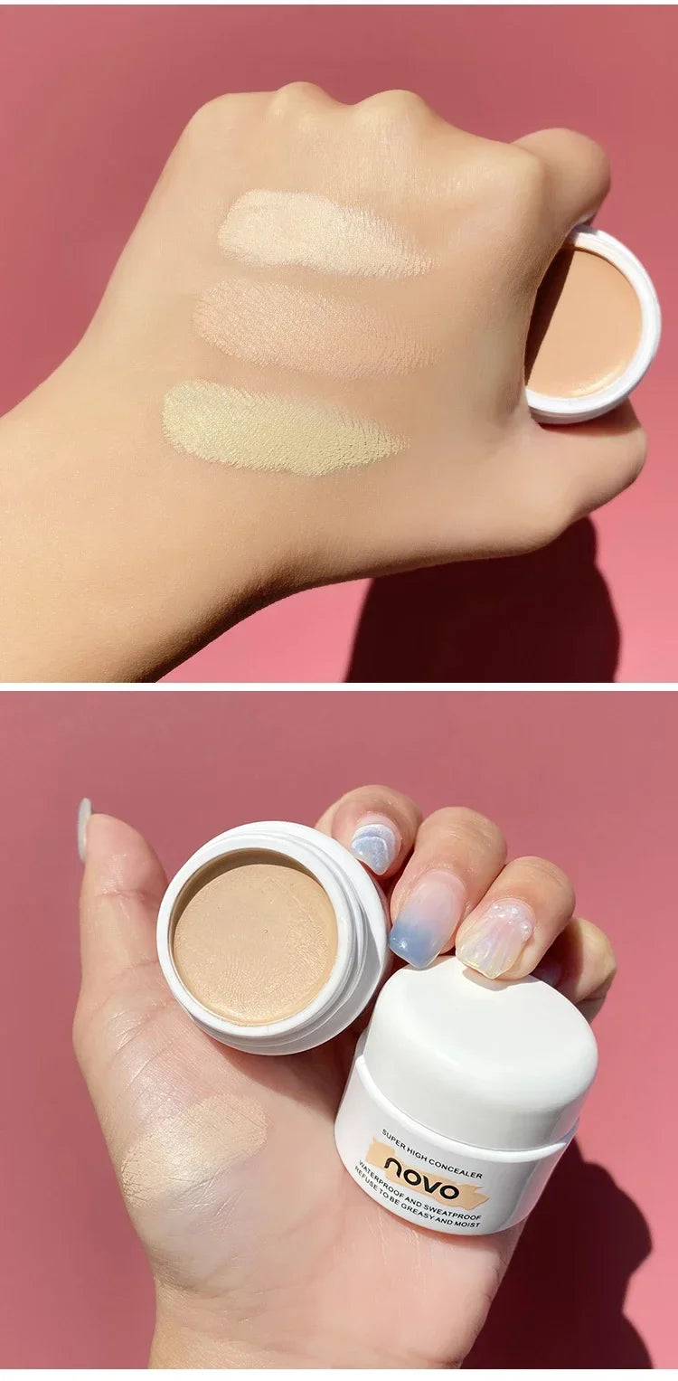 Hand holding a makeup product with swatches on a pink background